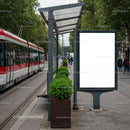 Modern tram stop with blank advertising billboard in city