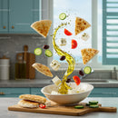 Mediterranean salad ingredients floating with olive oil swirl