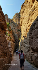 Scenic Mountain Canyon Passage with Rock Formations and Hikers
