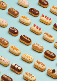 Variety of Elegant Mini Eclairs on Blue Background