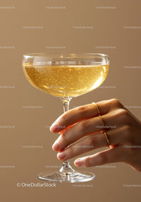 Close up of hand holding sparkling champagne glass