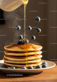 Stack of fluffy pancakes with blueberries and honey drizzle