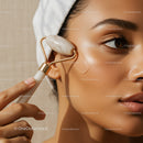 Young Woman Using Jade Roller for Facial Skincare Treatment