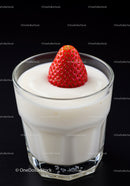 Fresh strawberry topped creamy yogurt dessert in glass