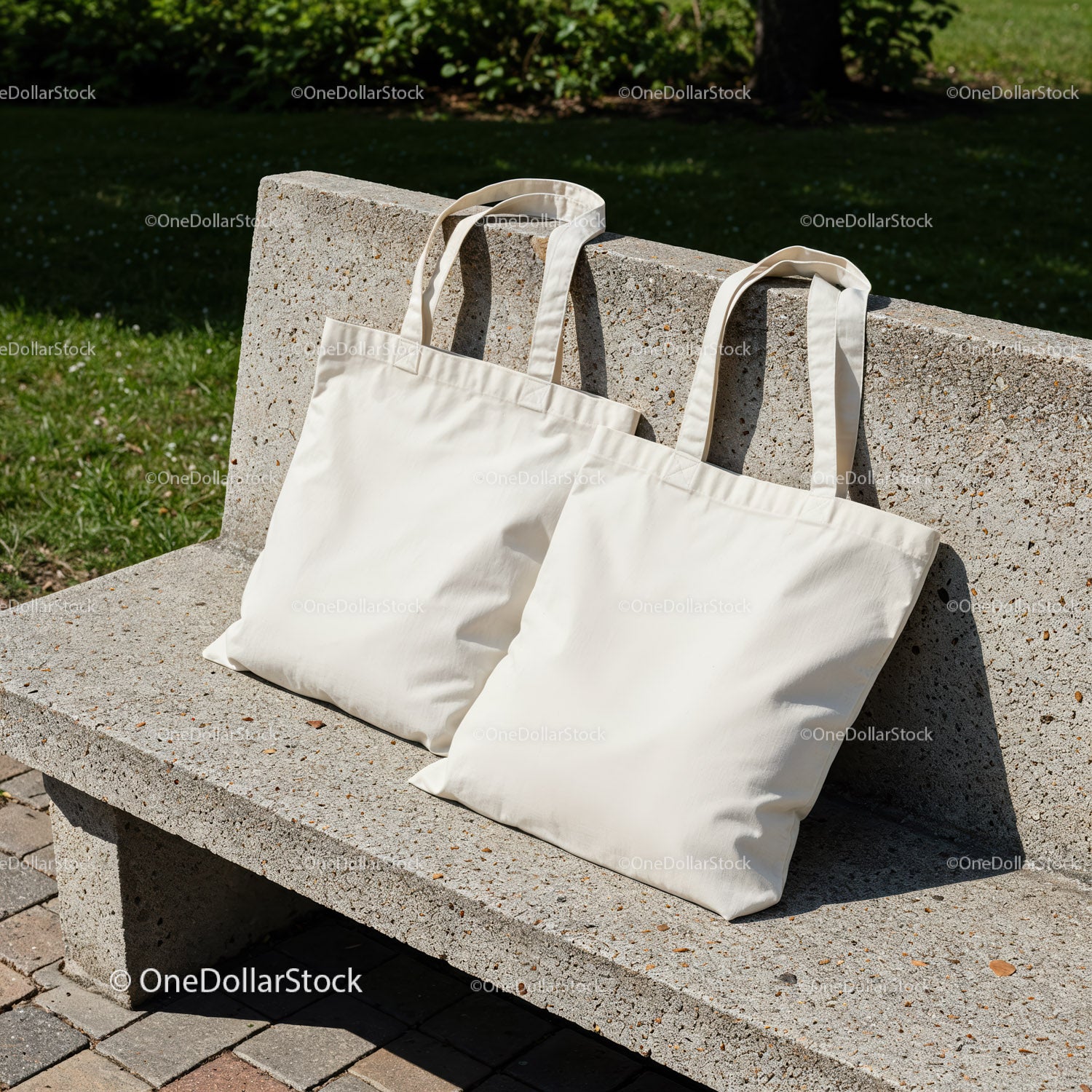 Two Plain Cotton Tote Bags Resting on Concrete Bench