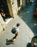Young Man Skateboarding on City Street in Urban Environment