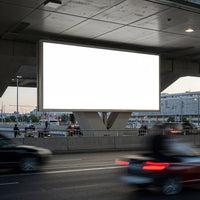 Blank urban billboard over busy city highway at dusk