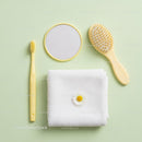 Minimalist Yellow Bath Accessories with White Towel and Flower