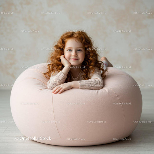 Ruda dziewczyna odpoczywająca na miękkim różowym fotelu typu beanbag
