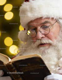 Santa Claus Reading a Vintage Book Near Christmas Tree