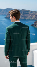 Man in Green Suit Looking at Scenic Seaside Cliffs