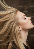 Blonde woman with flowing hair in serene profile pose