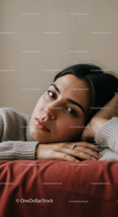 Young Woman with Relaxed Pose in Cozy Indoor Setting