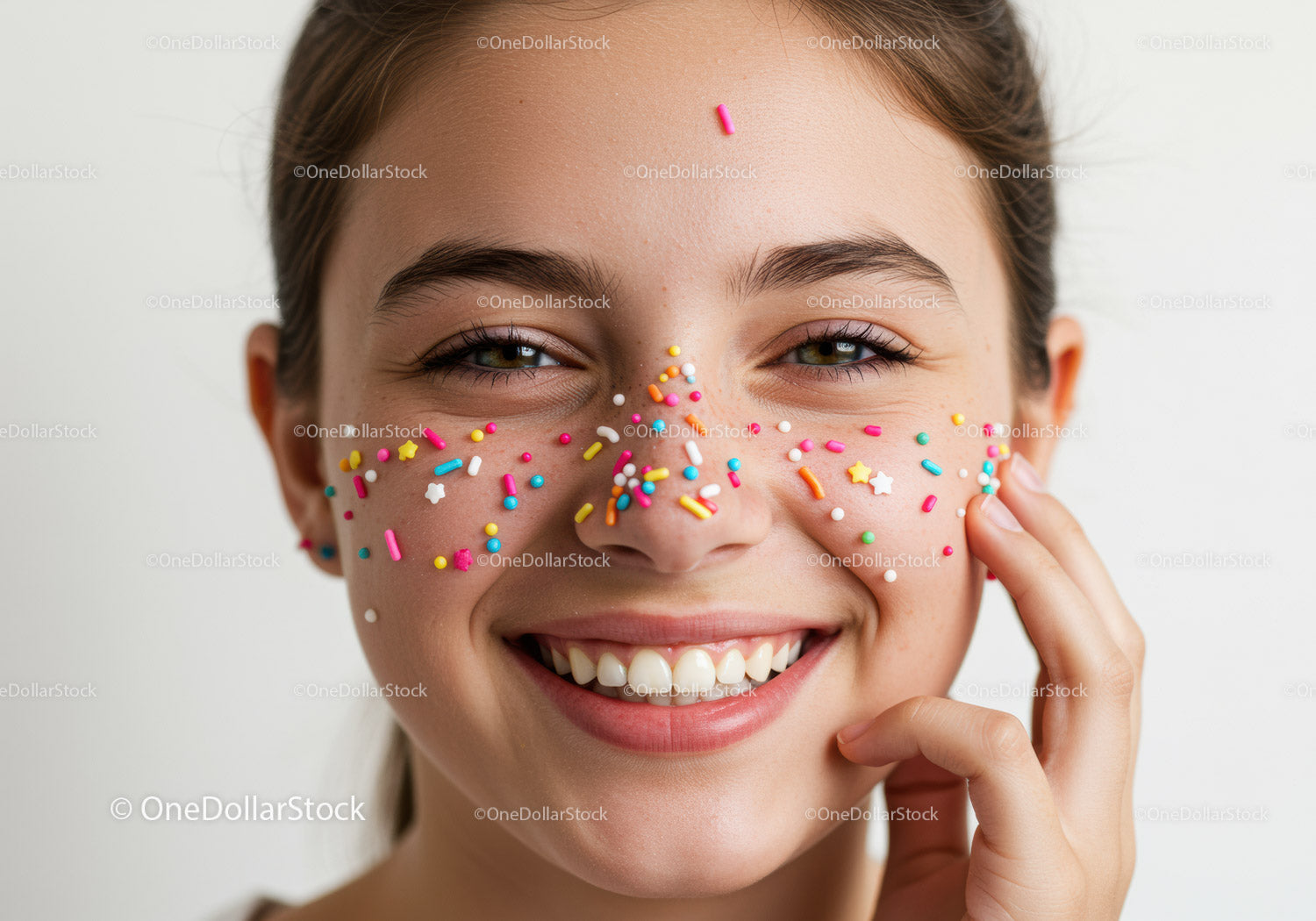 Young Woman with Colorful Sprinkles on Face Creating a Fun and Playful Look