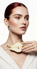 Portrait of Elegant Woman with Pear and Flawless Skin in Studio