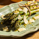 Grilled asparagus tied with twine and shaved parmesan