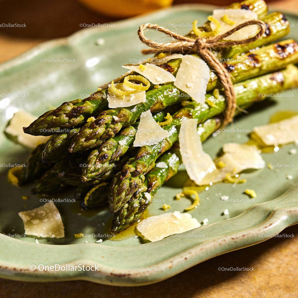 Grilled asparagus tied with twine and shaved parmesan