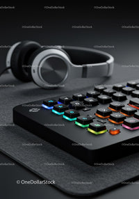 Wireless Headphones and RGB Backlit Gaming Keyboard on Desk