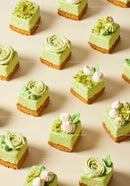 Assorted Mini Green Tea Cheesecake Desserts on Beige Background