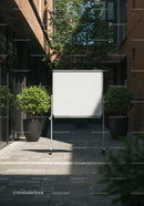 Blank Whiteboard in Modern Outdoor Courtyard Surrounded by Greenery