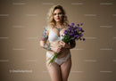 Tattooed Woman Holding Violet Flowers in Lingerie Studio Portrait