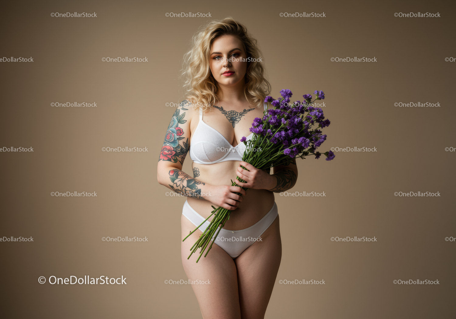Tattooed Woman Holding Violet Flowers in Lingerie Studio Portrait