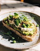 Avocado toast topped with ricotta and fresh peas