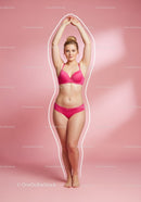 Young Woman in Pink Lingerie with Confident Pose on Pink Background