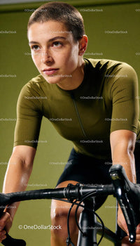 Determined cyclist training indoors on stationary bike