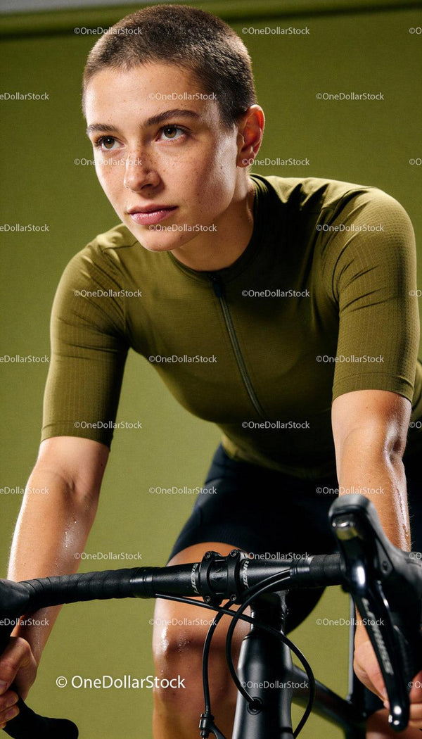 Determined cyclist training indoors on stationary bike