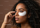 Young Woman with Curly Hair Applying Eye Patches for Skin Rejuvenation