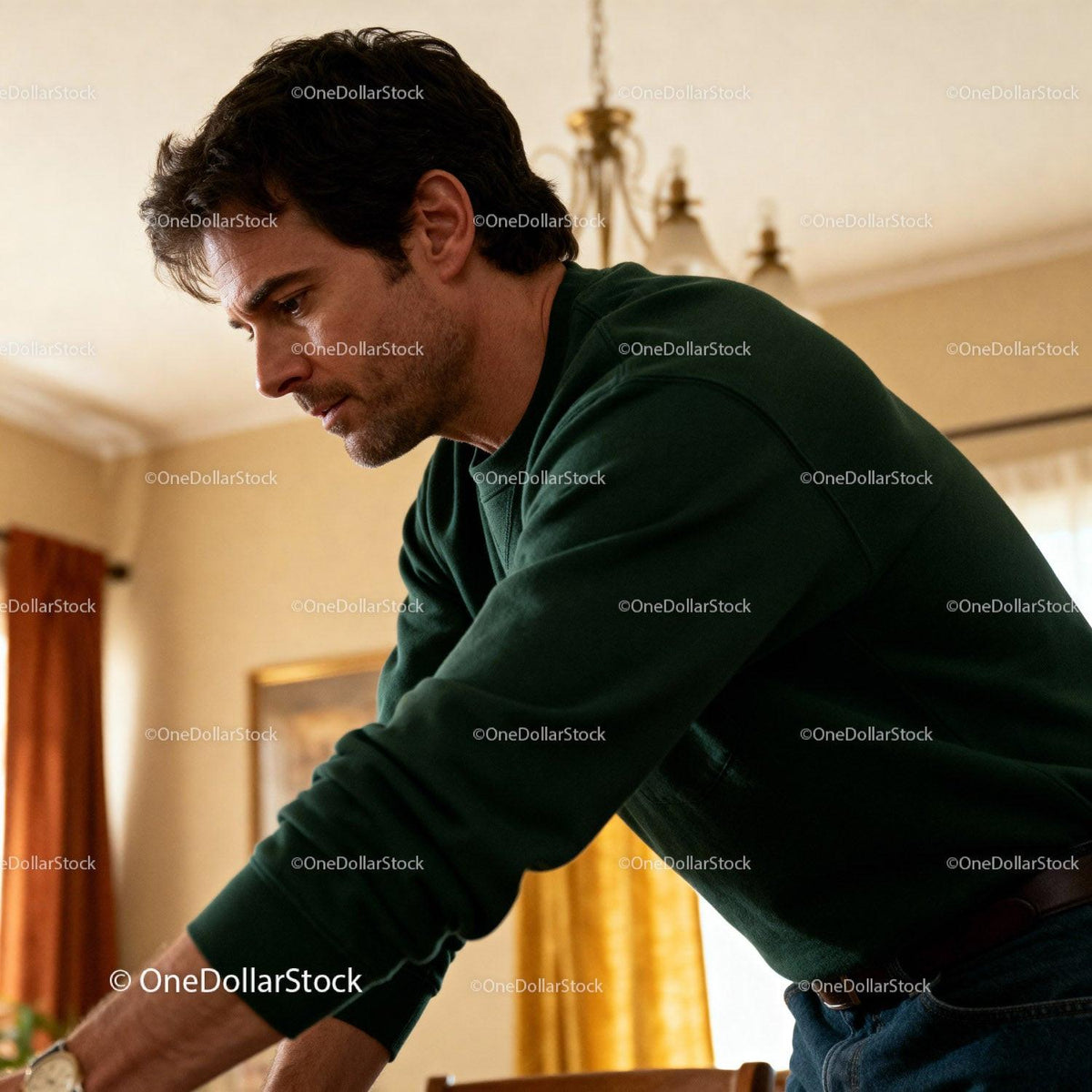 Thoughtful man leaning forward in cozy home setting
