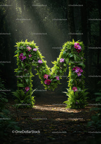 Floral letter M in lush forest under soft sunlight