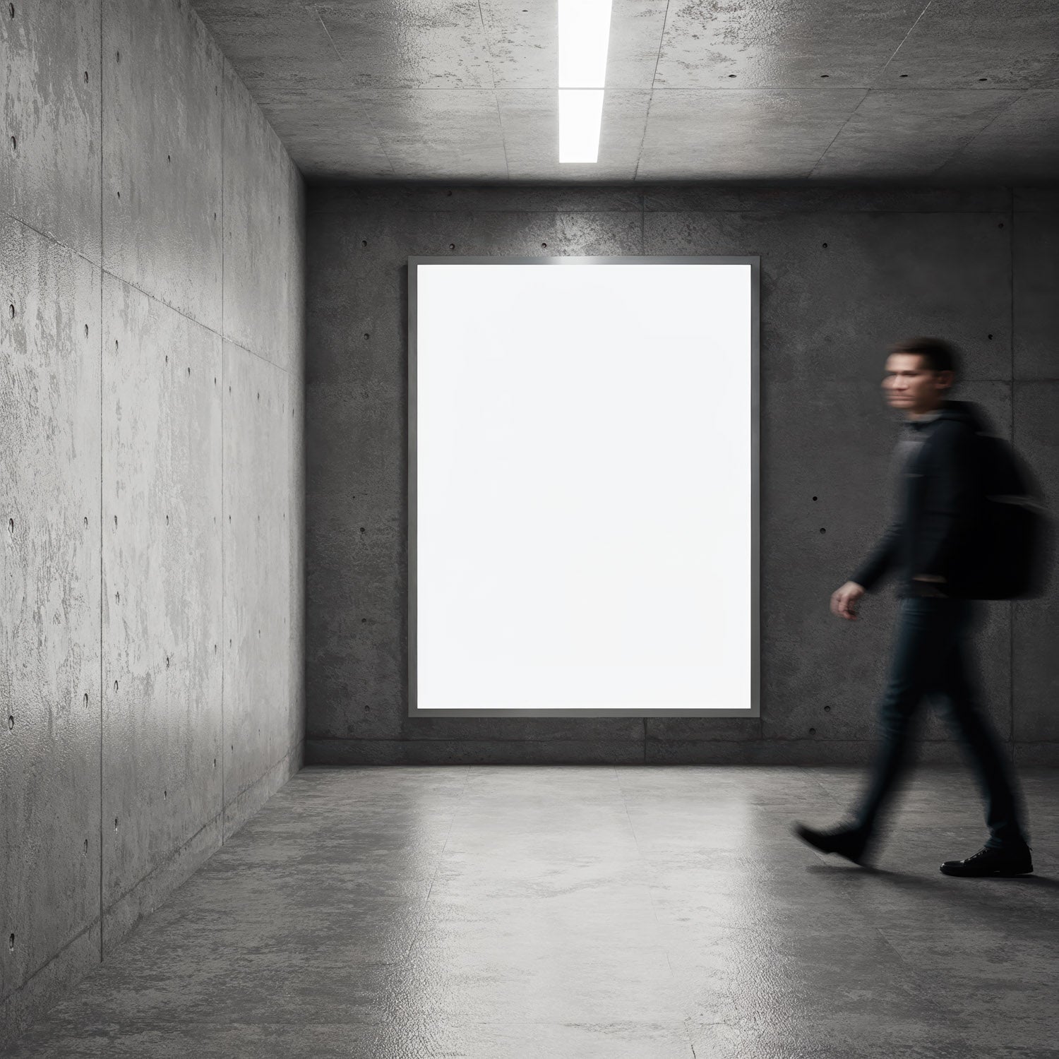 Person walking past illuminated blank poster in modern hall