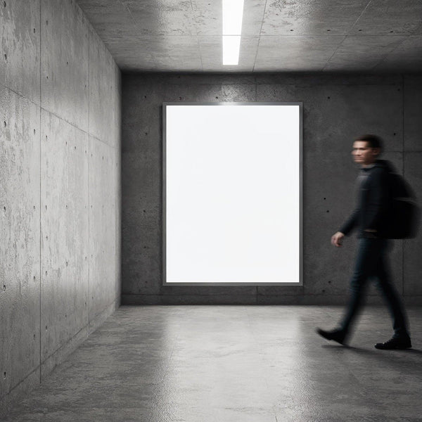 Person walking past illuminated blank poster in modern hall JPG Mockup Image