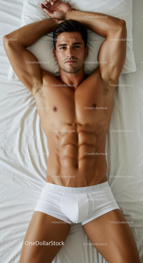 Fit young man relaxing on bed in white underwear