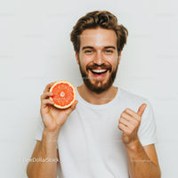 Joyful Man with Bright Red Grapefruit for Healthy Lifestyle Promotion