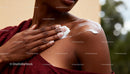 Woman Applying Moisturizer to Smooth Shoulder Skin