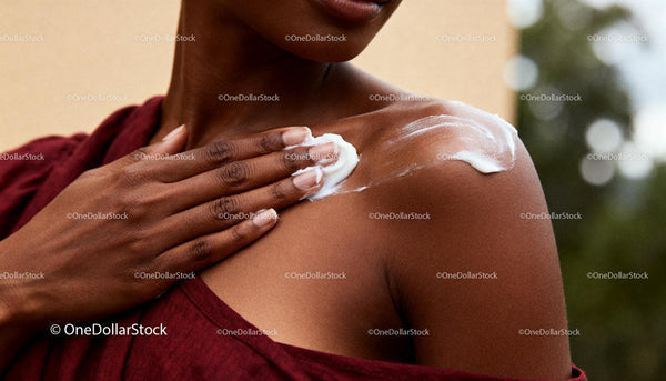 Woman Applying Moisturizer to Smooth Shoulder Skin