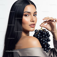 Elegant Woman with Long Black Hair Holding Black Grapes