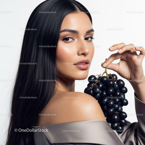 Elegant Woman with Long Black Hair Holding Black Grapes