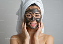 Woman with Black Mud Facial Mask Relaxing at Spa for Skin Rejuvenation