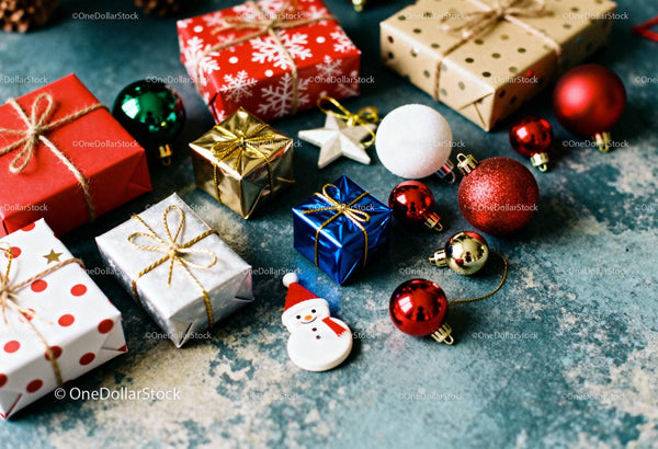 Colorful Christmas gifts and festive ornaments on table