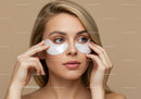 Female Woman Applying Under-Eye Patches for Skincare Treatment