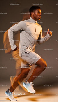 Male Athlete Running Dynamically in Studio Light