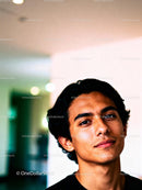 Confident young man with relaxed expression indoors