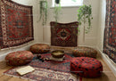 Cozy corner with patterned rugs and hanging plants