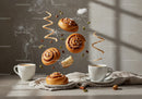 Fresh cinnamon rolls and coffee with spices in morning light