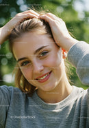 Young Woman Smiling Outdoors with Green Nature Background