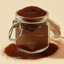 Glass Jar Filled with Fine Ground Coffee and Coffee Beans